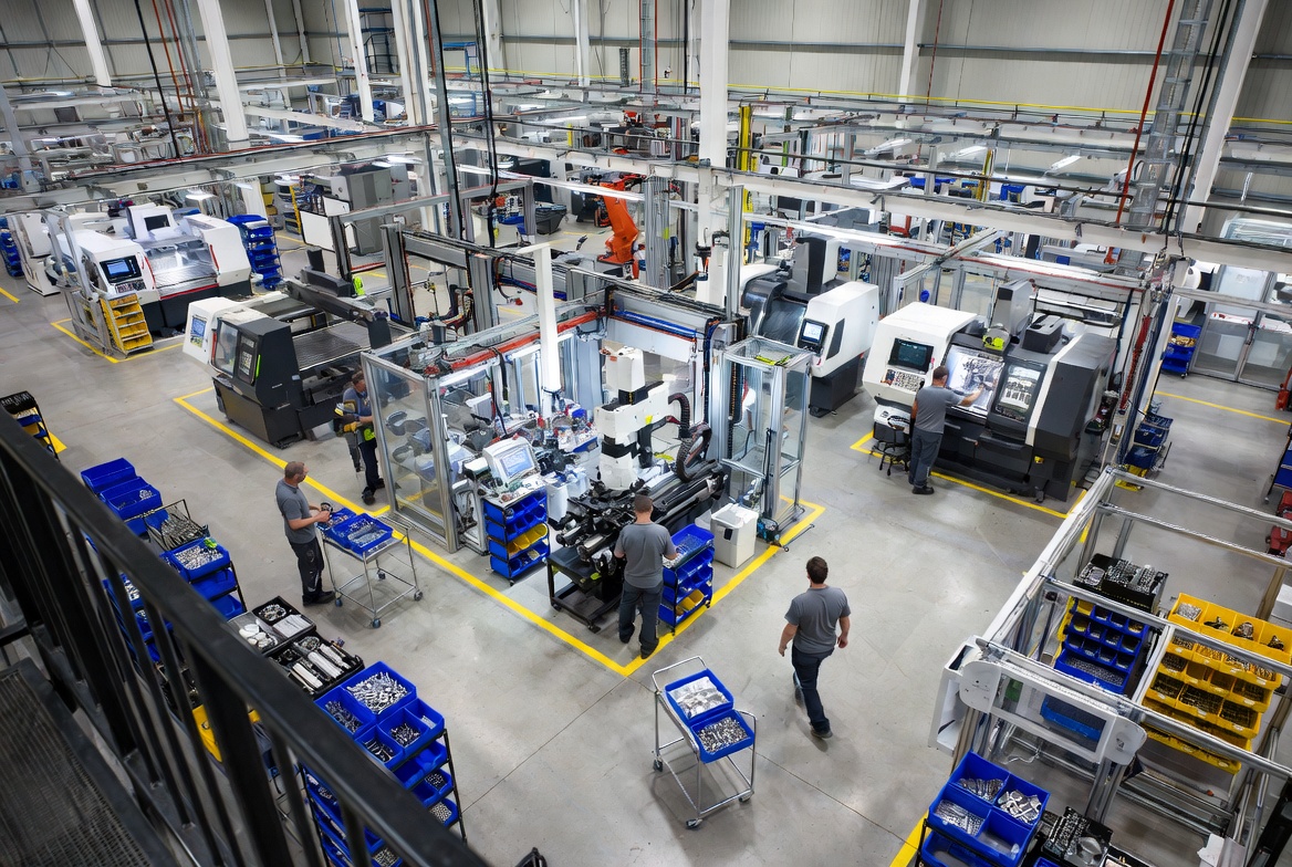 Modern factory floor with Kanban system in action — visual pull signals, material flow, and organized workstations demonstrating lean pull production